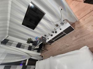 a bedroom with a bed and a television on a wall at schlafgut24 in Dortmund