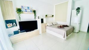 a living room with a bed and a flat screen tv at Island Village Sunset by Deihu Experiences in Adeje