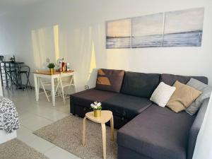 a living room with a couch and a table at Island Village Sunset by Deihu Experiences in Adeje
