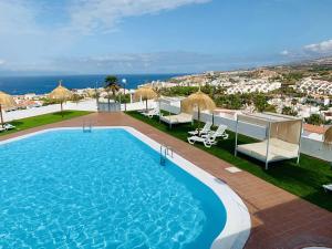 a swimming pool on the roof of a building at Island Village Sunset by Deihu Experiences in Adeje