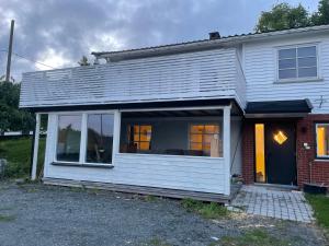 a white house with a large window on it at Larvik appartment in the city in Larvik