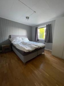 a bedroom with a bed and a window at Larvik appartment in the city in Larvik