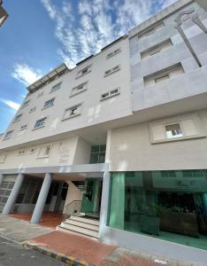 a large white building with a window at Hotel Buena Vista Express in Bucaramanga