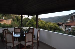 a table and chairs on a balcony with a view at Timber Guest House in Berat