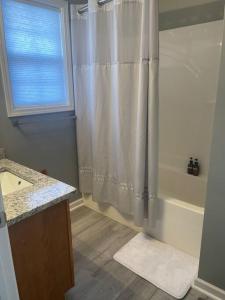 a bathroom with a shower with a shower curtain at Beautiful 3 BR Townhome - Recently Updated! in Bloomington
