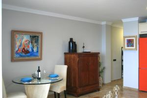 a dining room with a table and a painting on the wall at Las Canteras Beach in Las Palmas de Gran Canaria