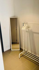 a white refrigerator in a room with a tiled floor at Élégant appartement (quartier européen) in Brussels