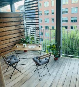 - Balcón con mesa de madera y sillas en un edificio en Élégant appartement (quartier européen), en Bruselas