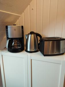a coffee maker and a toaster on a counter at Apartment Wittorf in Neumünster