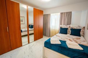 a bedroom with a bed and a large mirror at Quiet Marble Apt with Free Parking Spot Old Town in Bucharest