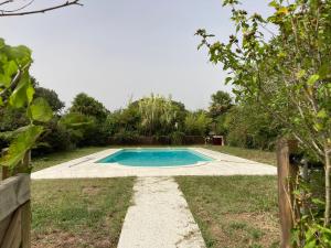 a swimming pool in the middle of a yard at Métairie de Moutiques in Cazaubon