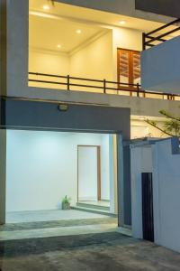 a house with a large door in the middle at Villa Double T Residence in Ambalangoda