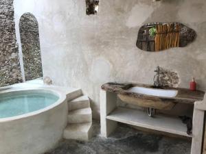 a bathroom with a bath tub and a sink at Casa Yaxunah in Yaxuná +33 photos