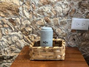 a basket on a table with a candle in it at Cenotefront House 20 min from Chichen Casa Yaxunah 