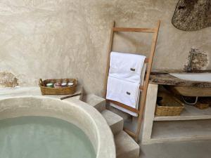 a bathroom with a bath tub and a sink at Cenotefront House 20 min from Chichen Casa Yaxunah 