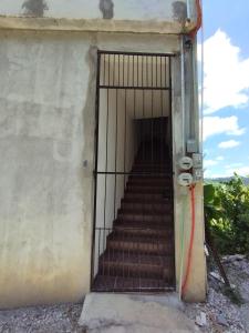 an iron gate with a staircase in a building at No disponible in Xilitla