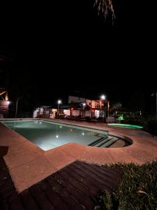 費德拉西翁的住宿－Dulce Retoño，一个夜晚有灯光的空游泳池