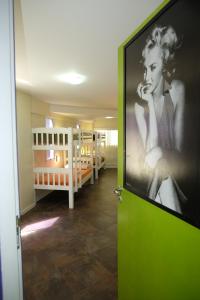 a room with two bunk beds and a green door at Hostel Toca da Moréia Bombinhas in Bombinhas