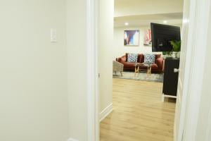 a hallway with a living room with a couch at Spacious 2-Bed-Room near Yonge & Major Mackenzie in Richmond Hill