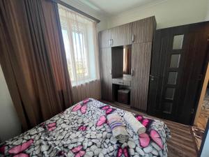 a bedroom with a bed with pink shoes on it at Apartment in Yerevan Rubinyanc 27 21 Zeytun in Yerevan