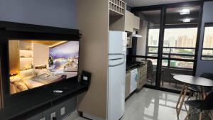 a kitchen with a large painting on the wall at Loft Família c/ 2 Quartos e Lava e Seca no Vertigo in Campo Grande
