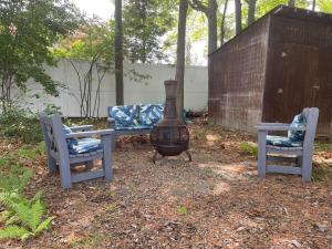 a vase sitting on a table next to two chairs at Cute ranch house, less than 1 mile to downtown and skidmore. 2 miles to the track and SPAC in Saratoga Springs +1 photo
