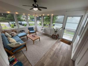 a living room with a blue couch and a table at Cute ranch house, less than 1 mile to downtown and skidmore. 2 miles to the track and SPAC in Saratoga Springs
