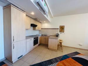 a kitchen with white cabinets and a stove top oven at شقق تالابيه talabay apartment swimming pools and sea view Aqaba in Aqaba