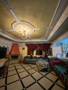 a living room with couches and a chandelier at Villa Hanaa in Mohammedia