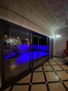 a room with a view of a pool and a ceiling at Villa Hanaa in Mohammedia