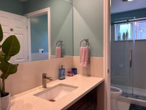 a bathroom with a sink and a mirror at San Francisco 3BR3BA w free parking near airport in Daly City
