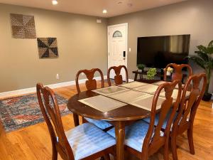 a dining room with a table and chairs and a television at San Francisco 3BR3BA w free parking near airport in Daly City