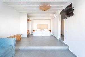 a living room with a bed and a couch at SEA SIDE APARTMENTS IN ORNOS BEACh in Ornos