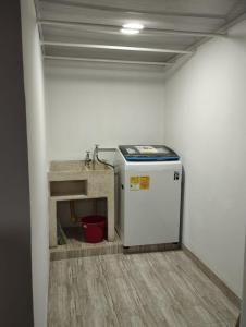 a small refrigerator in a room with a sink at Mi casa tu casa in Santa Rosa de Cabal