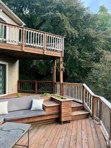 a wooden deck with a couch on a porch at Mountain house in Palmerton