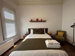 a bedroom with a large bed and a chair at Historic Greek Pavillion Golden Horn Istanbul in Istanbul