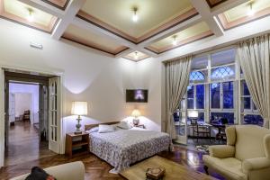 a bedroom with a bed and a living room at Villa Mediteran in Dubrovnik