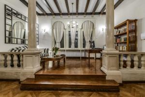 a living room with columns and a table and chairs at Villa Mediteran Old Town, 5 En-Suites and Hot Tub in Dubrovnik
