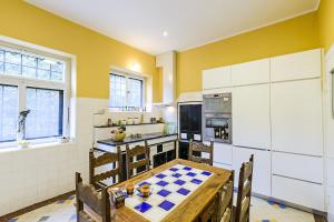 a kitchen with a table with a checker board on it at Villa Mediteran Old Town, 5 En-Suites and Hot Tub in Dubrovnik