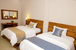 En eller flere senge i et værelse på Maravilla Kivu Eco Resort
