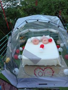 a bed in a tent with hearts on it at The Green Jungle & Tree House Caribe in Puerto Viejo