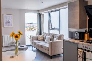 a living room with a couch and a table at No. Two - Harbour Views in Poole