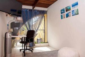 a room with a desk and a chair and a window at Aurora Mari Villa Your Dream Steps from the Ocean Shore in Caleta De Fuste