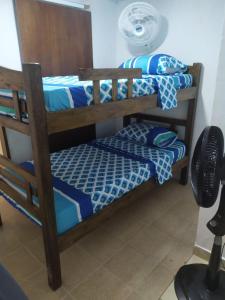 a room with two bunk beds and a fan at Casa Caribe in Santa Marta