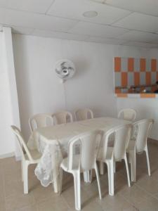 a white table and chairs in a room at Casa Caribe in Santa Marta