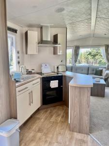 a kitchen with a stove top oven in a caravan at The Ascot by North Shacks in Slaley