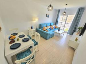 a living room with a blue couch and a table at Casa Zicman Las Teresitas in San Andrés