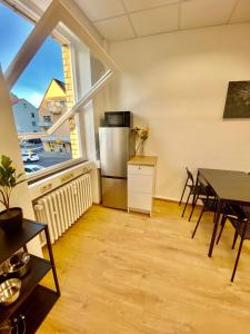 a kitchen with a table and a refrigerator and a window at Smart In Göttingen - Apartments & Rooms in Göttingen