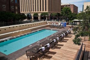 uma grande piscina com cadeiras e um edifício em DoubleTree Suites by Hilton Hotel Austin em Austin