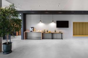 an empty lobby with a podium and a presentation at Park Inn by Radisson Vilnius Airport Hotel & Conference Centre in Vilnius